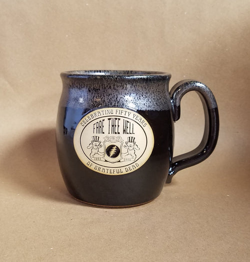 Title:  Grateful Dead 50th Anniversary Mug  Artist:  Sunset Hill Stoneware  Notes:  Black with grey detailing around top and handle.  Handcrafted in America in an environmentally-friendly facility utilizing green initiatives. Oven, microwave and dishwasher safe.
