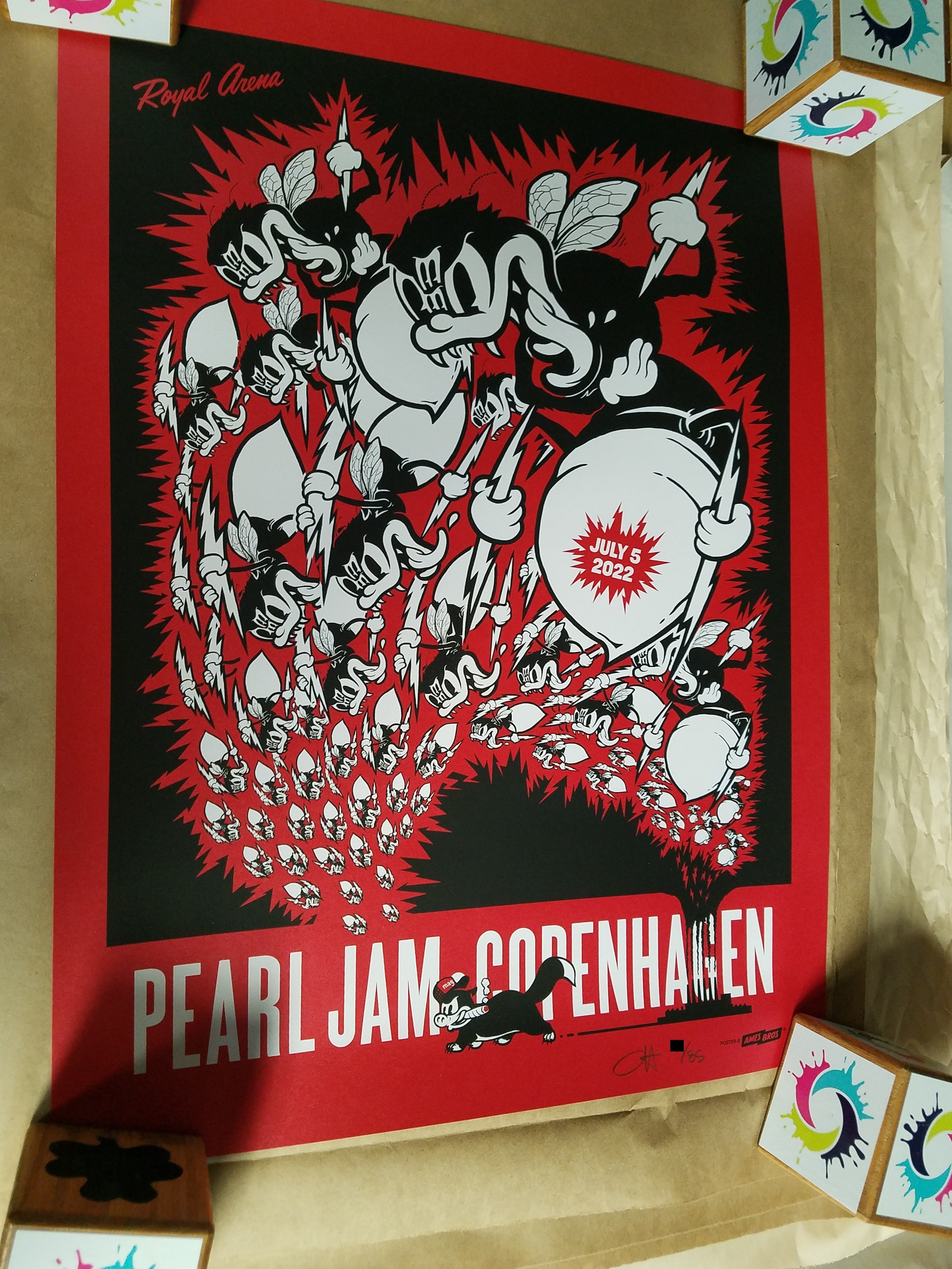 Title:  Official Pearl Jam Copenhagen 2022 (Red Metallic Variant)  Artist:  Ames Bros  Edition:  Red Metallic Variant xx/85, signed and numbered by the artist  Type: 2 Color silkscreen poster on red metallic paper  Size: 18" x 24"  Location:  Copenhagen, Denmark  Venue:  Royal Arena