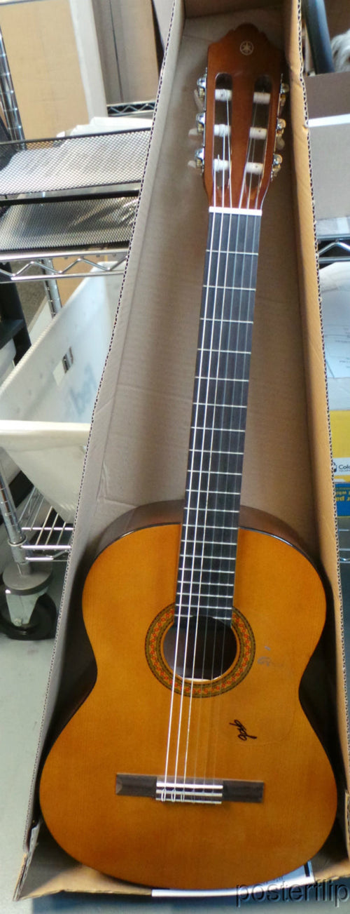 Yamaha nylon-string acoustic guitar autographed by acoustic guitar duo Rodrigo y Gabriela.